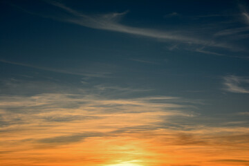 Dark evening sky with clouds and the last rays of the disappearing sun