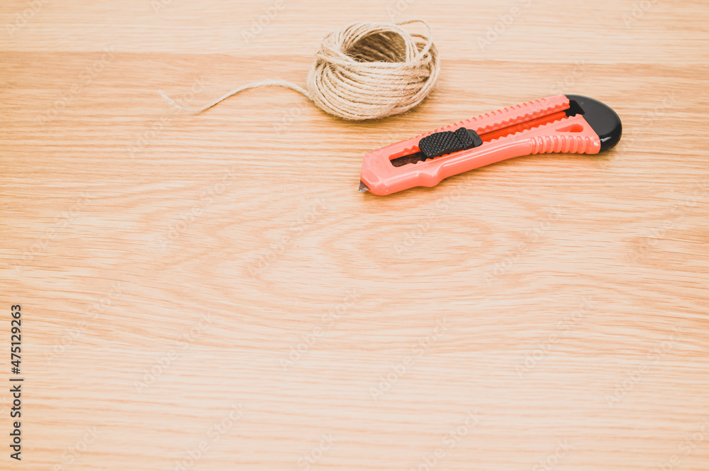 Canvas Prints cutter and rough string on a wooden tabletop