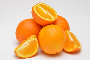 grou p of objects whole and cut oranges on a white background