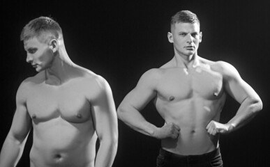 Strong men twins with abdominal strength, fit males with muscular six pack abs.