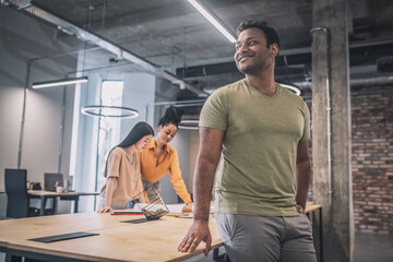 Fototapeta premium Smiling confident guy looking optimistic to side