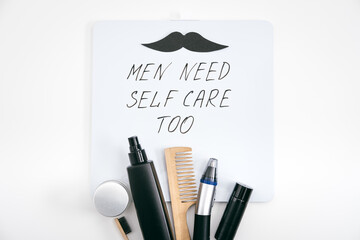 Men self care kit with male beauty care products and devices and letter board with text Men need...