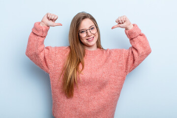 caucasian red hair woman feeling proud, arrogant and confident, looking satisfied and successful,...