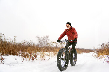 Nice Man riding a fat bike in winter