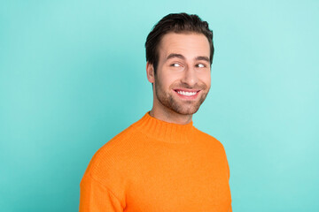 Profile portrait of cheerful glad man beaming smile look interested empty space isolated on teal color background © deagreez