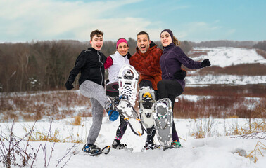 family hiking with snowshoes racket in winter day