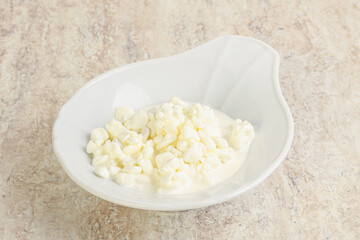Grained cottage cheese in the bowl