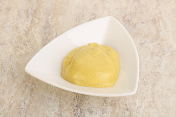 Organic mustard sauce in the bowl