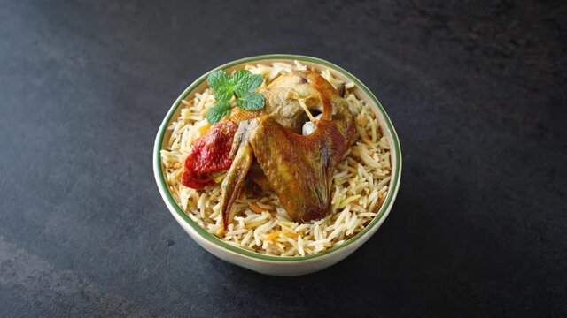 Arabic chicken Manthi mandi cooked meat, Basmati rice with Masala, spice. Kuzhimanthi hot spicy Manthi black background 4K video footage Malabar Kerala, South India. Top view of Indian non veg food.