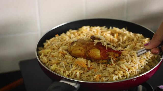 Arabic chicken Manthi mandi cooked meat Basmati rice with Masala spice woman hand serving cooking Kuzhimanthi hot spicy Manthi 4K video footage Malabar Kerala South India Indian non veg food Sri Lanka