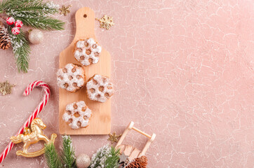 Christmas baked goods and Christmas decorations on beige background with copy space