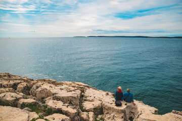 Fototapeta premium Pula, Croatia - May 21, 2019: senior couple sitting enjoying view of sea bay