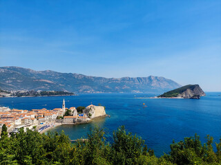 The view of St. Nicholas Island and Budva medieval fortress of St. Mary, Citadel, landscape of Old town Budva, Montenegro, beautiful seascape
