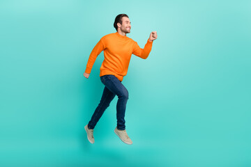 Fototapeta na wymiar Full body profile side photo of young man runner hurry look empty space motion jump isolated over teal color background