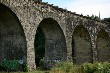 Fototapeta na wymiar The largest and oldest viaduct in Ukraine, a brick and old railway bridge.