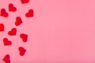 Valentines day background with red hearts on a pink background, free space for text