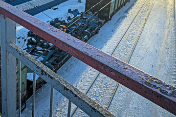 View through the fence of the pedestrian crossing on the railway on a sunny winter day