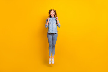Fototapeta na wymiar Full size photo of cool teen girl jump wear bag jeans shirt footwear isolated on yellow background