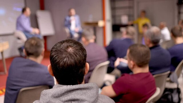 Group business trainer giving presentation to group of audience people. Male Speaker man seminar public on stage speaking conference, Meeting, Businessman colleagues team training corporate coaching