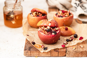 Red baked apples with oatmeal , walnuts and honey. Autumn winter dessert	
