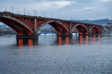 Automobile Communal Bridge (1961) with night illumination across the Yenisei River in the city of Krasnoyarsk. Russia.