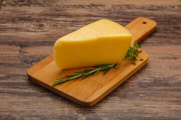 Hard cheese piece served rosemary