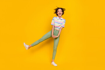 Fototapeta na wymiar Full length photo of young girl amazed excited have fun happy positive smile isolated over yellow color background
