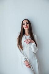 portrait of a beautiful woman in a light summer dress on a white background