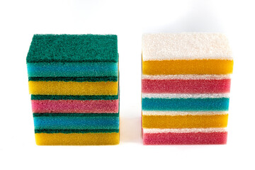 Set of different bright colored foam sponges for everyday cleaning in kitchen and washing dishes. Sponges in pink, green, yellow, blue and orange colors on white background. Close-up, horizontal.