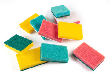 Set of different bright colored foam sponges for everyday cleaning in kitchen and washing dishes. Sponges in pink, green, yellow, blue and orange colors on white background. Close-up, horizontal. - obrazy, fototapety, plakaty