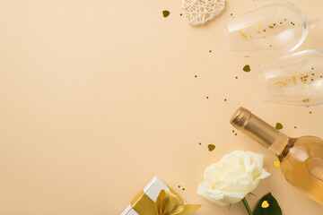 Top view photo of white rose rattan heart two wineglasses with golden sequins heart shaped confetti...