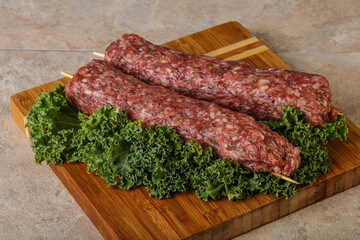 Raw minced beef kebab skewer