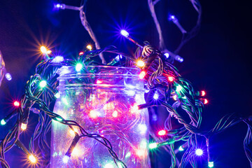 Christmas and holiday theme lights in a jar .