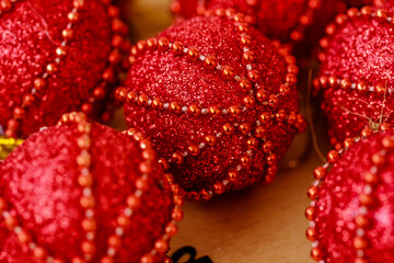 Macro of bright red Christmas balls on wooden background, Christmas