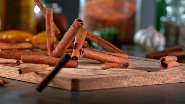 Super slow motion of falling cinnamon spice on wooden board. Filmed on high speed cinema camera, 1000 fps. Speed ramp effect.