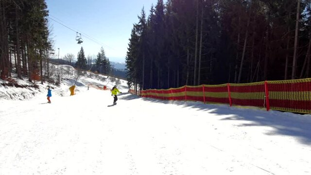 people skiing and snowboarding by slope