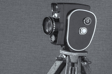 Old movie camera on a tripod - 475157869