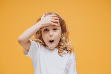 Cute little girl showing emotions, isolated on yellow background