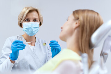 Stomatologist preparing to examine the patient's oral cavity