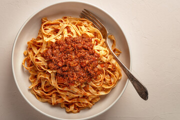 Top view plate of pasta tagliatelle with BOLOGNESE SAUCE close-up