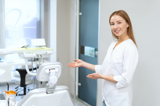 Dentist invitates people sitting in chair in modern clinic office