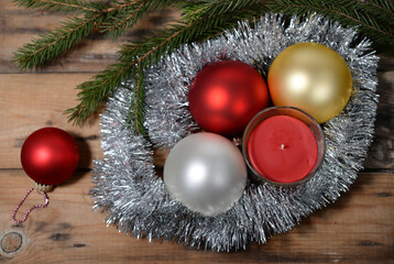 Christmas background with red candle, baubles, silver tinsel 