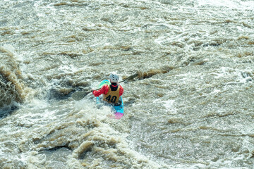 one person kayaking in a fast mountain river