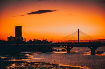 Obraz premium Beautiful sunset in the city of Badajoz, golden hour orange sky at dusk in a city.