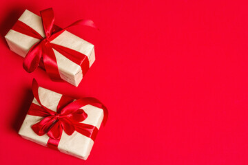 Zero waste gift boxes with festive ribbons on matte rad background