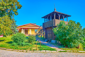 The wooden tower of former fortress and the restaurant on background, Poltava, Ukraine