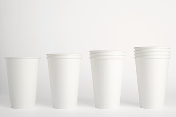 White paper disposable cups isolated on white background. Free space for your brand