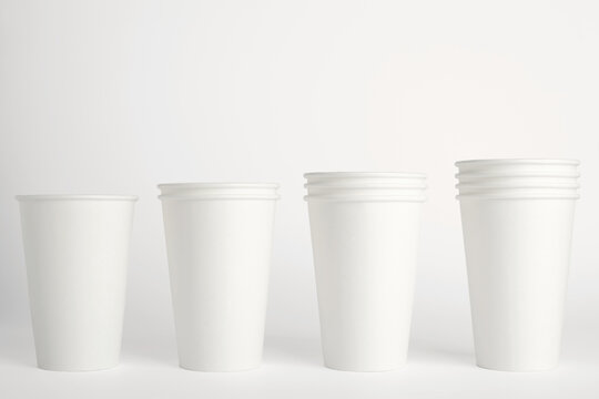 White paper disposable cups isolated on white background. Free space for your brand