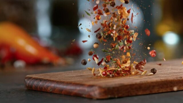Super slow motion of falling spice mix on wooden board. Filmed on high speed cinema camera, 1000 fps.