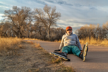 inline skating on a paved bike trail along Poudre River in Fort Collins, Colorado - senior male...